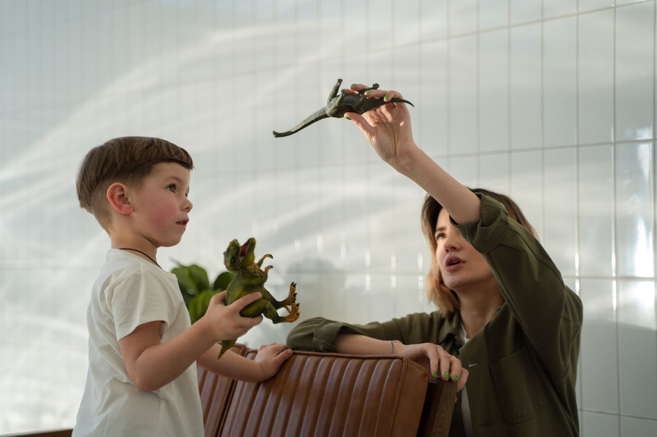 Mother and Son Playing a Toy Dinosaur Together